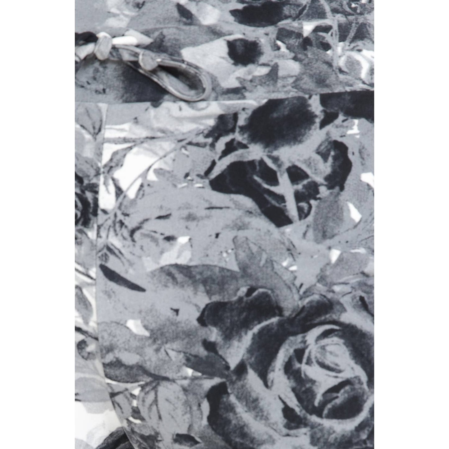 Close-up of Leggings Depot Buttery Soft Print Pajama Pants in a black and white floral design, showing a visible seam and part of a gray plastic clasp at the waist.