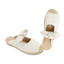 The Brussells Canvas Espadrille Open Back Mule by Top Guy features a beige design with closed toes, fabric bows on top, and woven toe accents.
