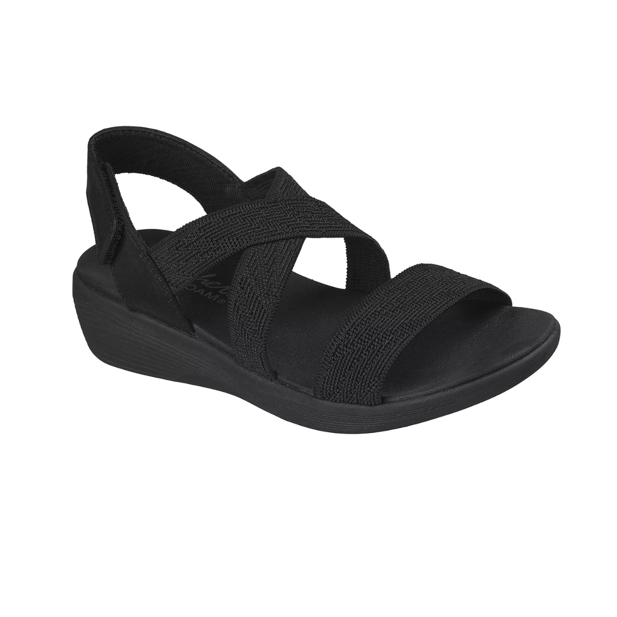 The SKECHERS Arya Very Midful Low Wedge Heel Sandal is a black open-toe slip-on with crisscross elastic straps and a low wedge heel, shown from the front.