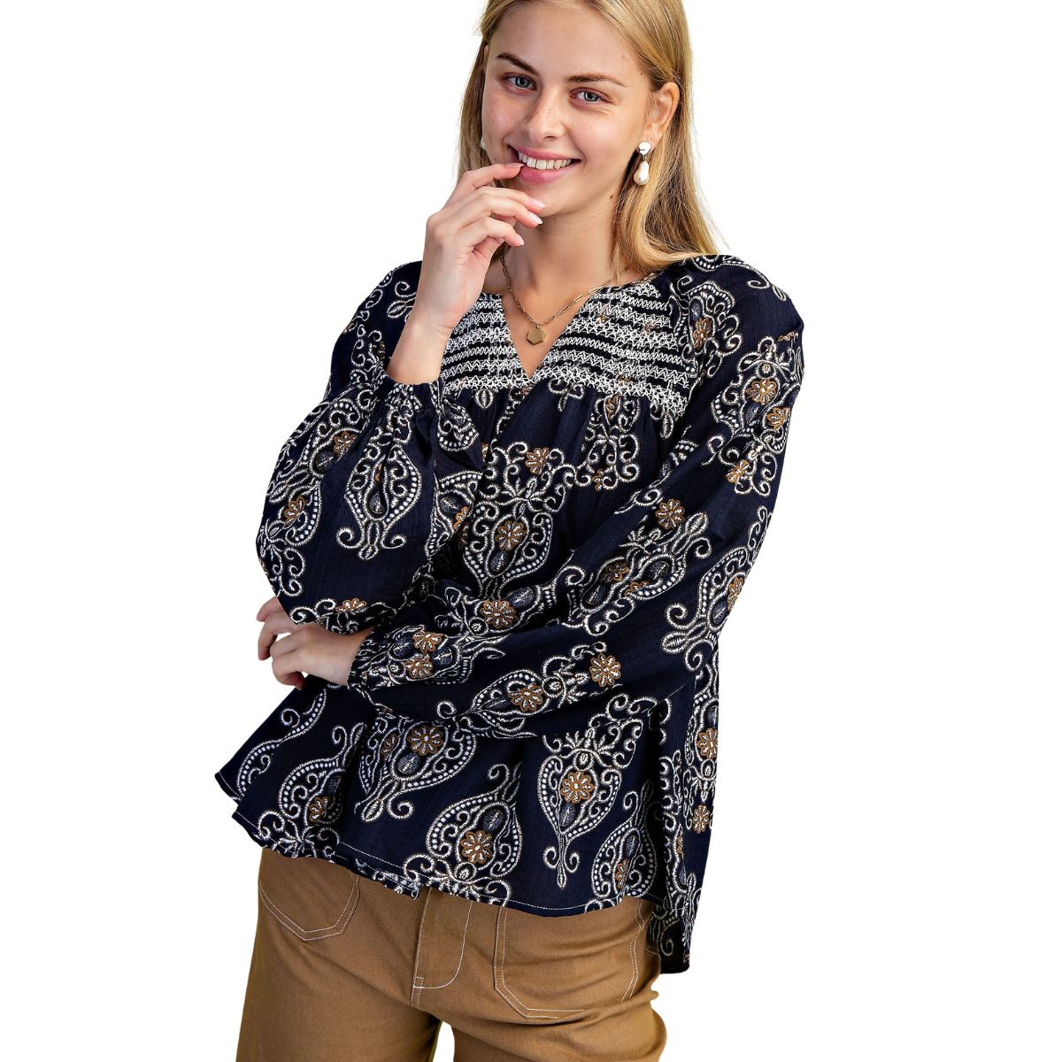 A person wears the FASHION GO Printed Balloon Sleeve V-neck Blouse and brown pants, smiling with one hand on their chin against a white background.