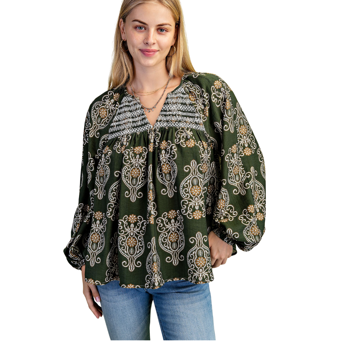 A woman wearing the FASHION GO Printed Balloon Sleeve V-neck Blouse with a paisley print and blue jeans, standing against a white background.