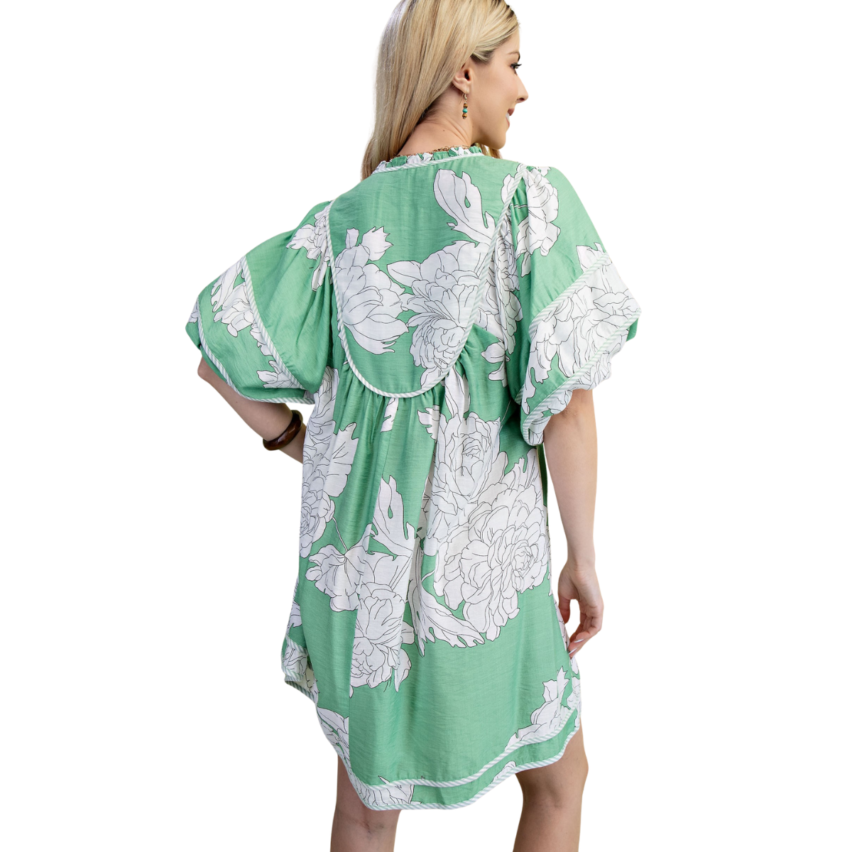 A woman is shown from the back wearing the FASHION GO Floral Print Babydoll Dress, a loose, short-sleeve dress with a green base and large white floral print, set against a white background.
