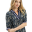 A woman stands with one arm crossed and a slight smile, wearing the Umgee Spring Burst Top in Navy Floral featuring puff sleeves and striped trim.