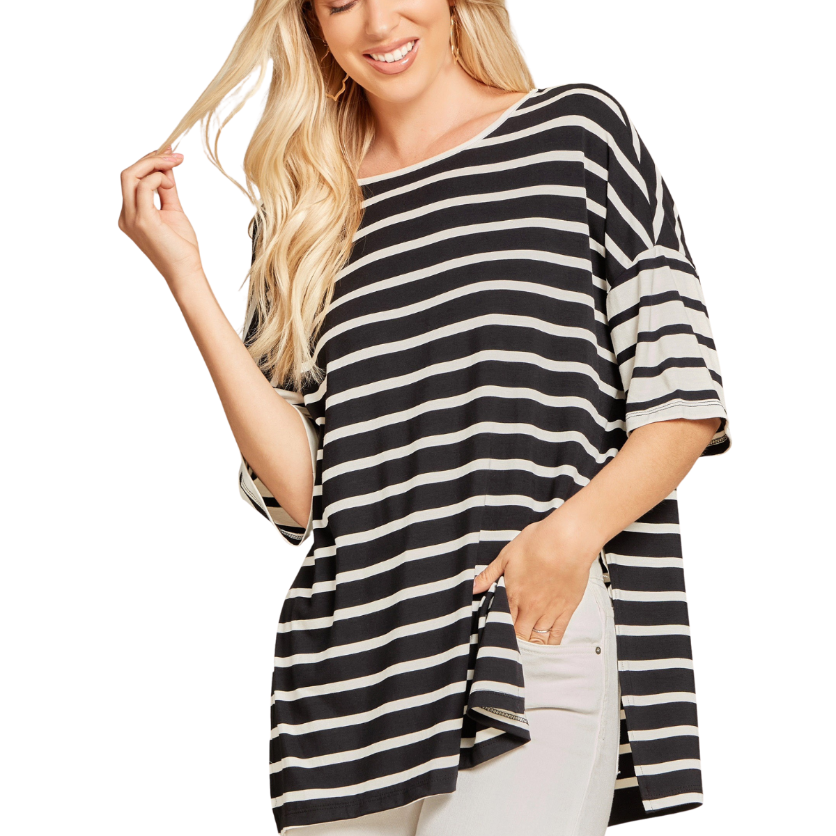 A woman smiles warmly as she holds a strand of hair, wearing a FASHION GO Striped T shirt Top—black and white stripes, short sleeves—paired with light-colored pants.
