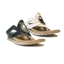 Two MODZORI Lirah #1 Reversible Black to Blone sandals with textured soles, one black and one beige, both featuring cutouts and decorative stitching, are displayed on a white background.