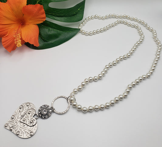 A Flipflops & Whatnots Silver Heart Handmade Necklace adorned with a heart pendant and pearl bead accents.