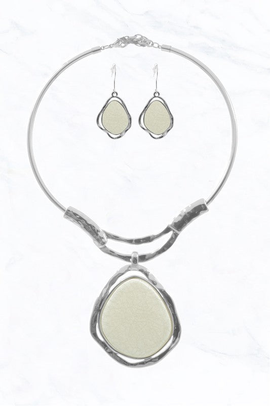 The Abstract Elegance Choker Set by FASHION GO features a silver abstract necklace and matching drop earrings, each adorned with a large cream-colored stone framed by irregular silver outlines.
