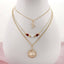 The Alabama Gold & Tube Bead Trio Necklace Set by Seasons Jewelry features three elegant gold-layered chains: a script letter charm, a beaded strand with red and gold beads, and a round pendant engraved with "Alabama Crimson Tide." This collegiate necklace set is the perfect piece of Bama jewelry, beautifully showcased on a white display bust.