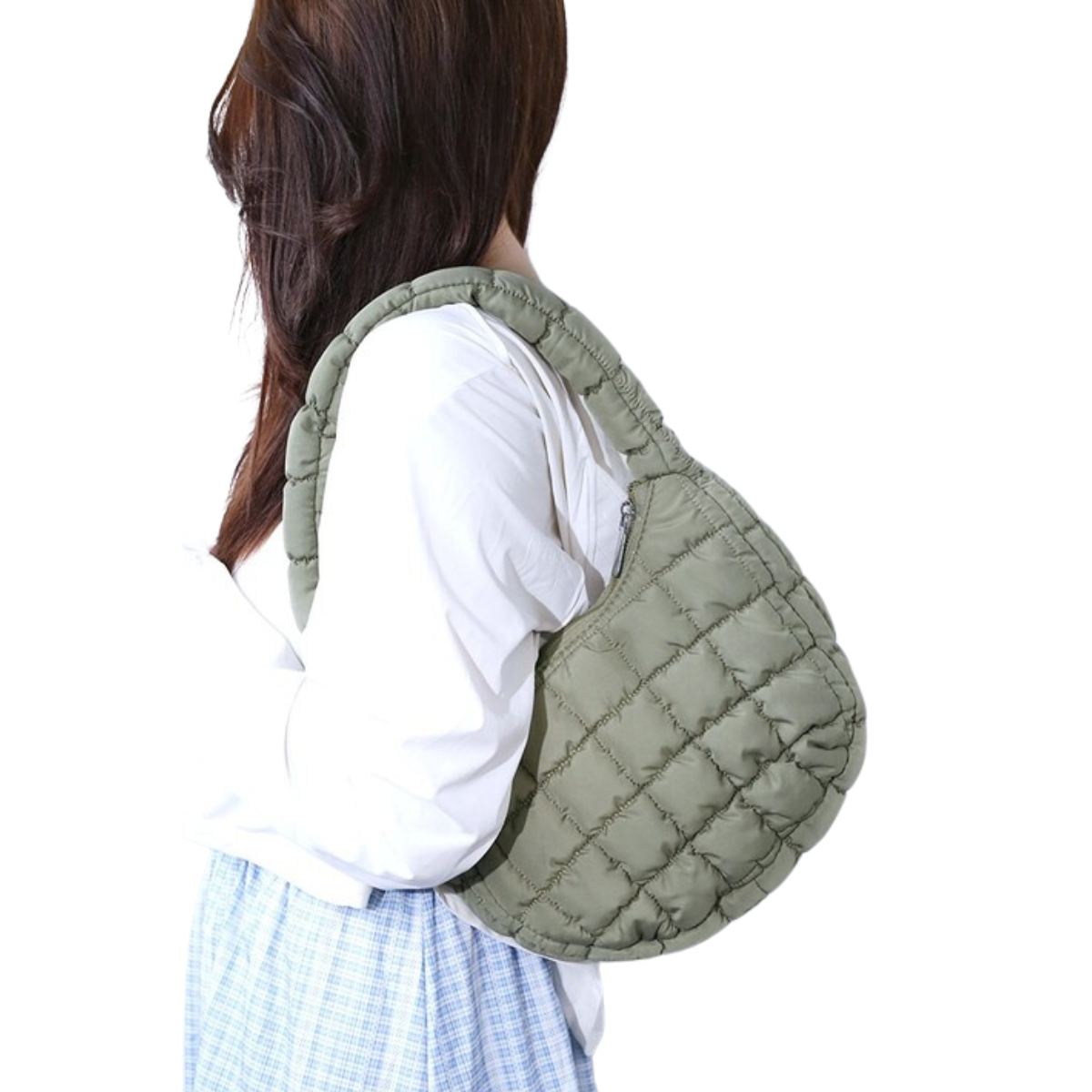 A person with long hair, wearing a white shirt and plaid skirt, holds a Zenana Puffer Quilted Mini Bag Assorted Colors over their shoulder.