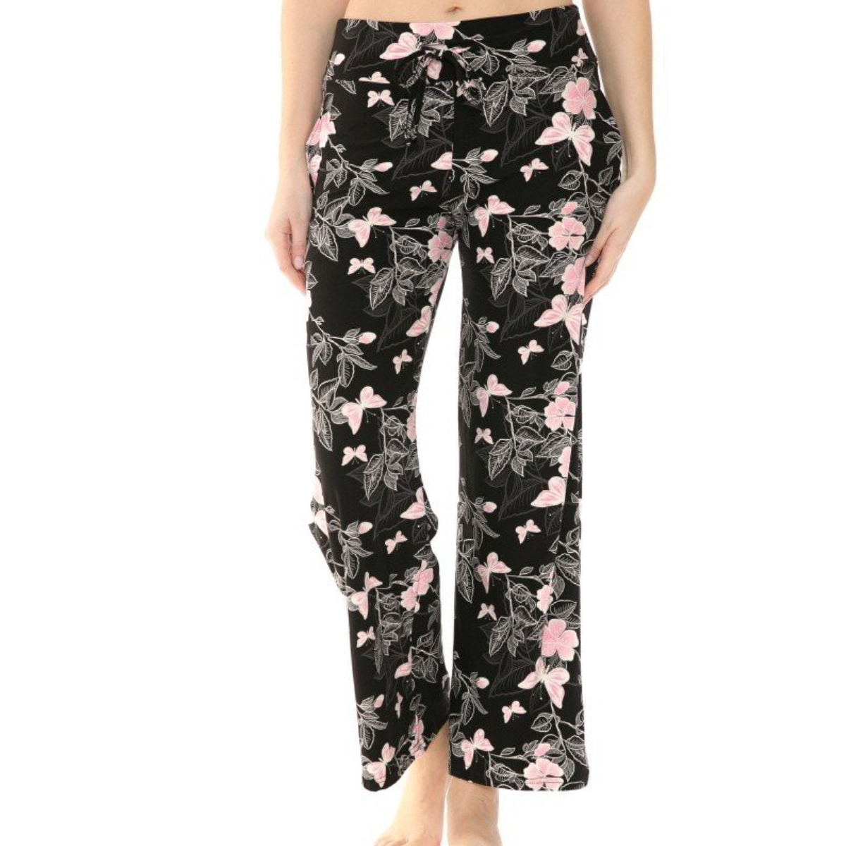 Person wearing FASHION GO's Buttery Soft Pajama Pants with a pink and white floral pattern, featuring an elastic waistband, standing barefoot.