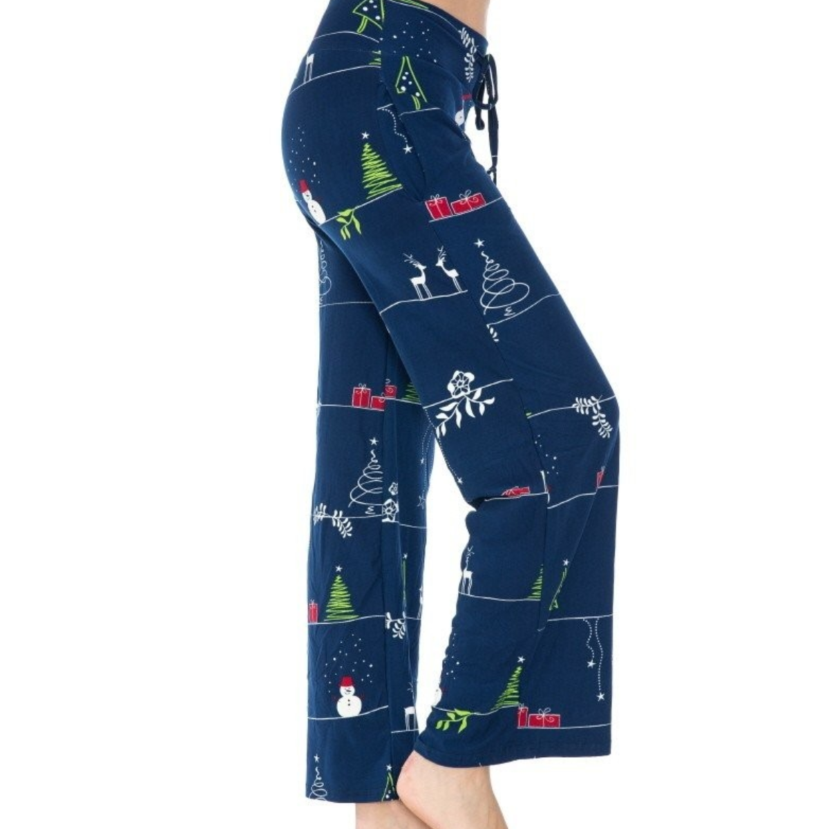 A side view showcases someone in blue FASHION GO's Buttery Soft Pajama Pants with a festive winter print of trees, snowmen, and gifts. These pants feature a drawstring elastic waistband for added comfort and functional pockets for convenience, embodying the essence of relaxation as they stand barefoot.