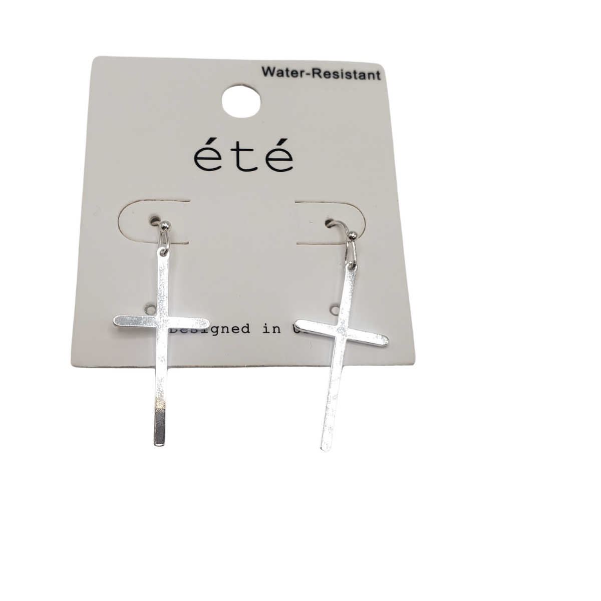 Silver cross earrings on a white "été" card, branded SPECIAL EFFECTS, water-resistant and featuring an elegant silver tone.