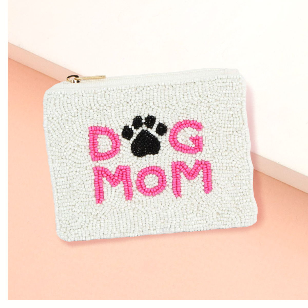 The Wona Trading Seed Bead Accented Mini Pouch Bag Assorted features "DOG MOM" in pink, a black paw print bead design, and makes a stylish gift for pet-loving fashionistas.