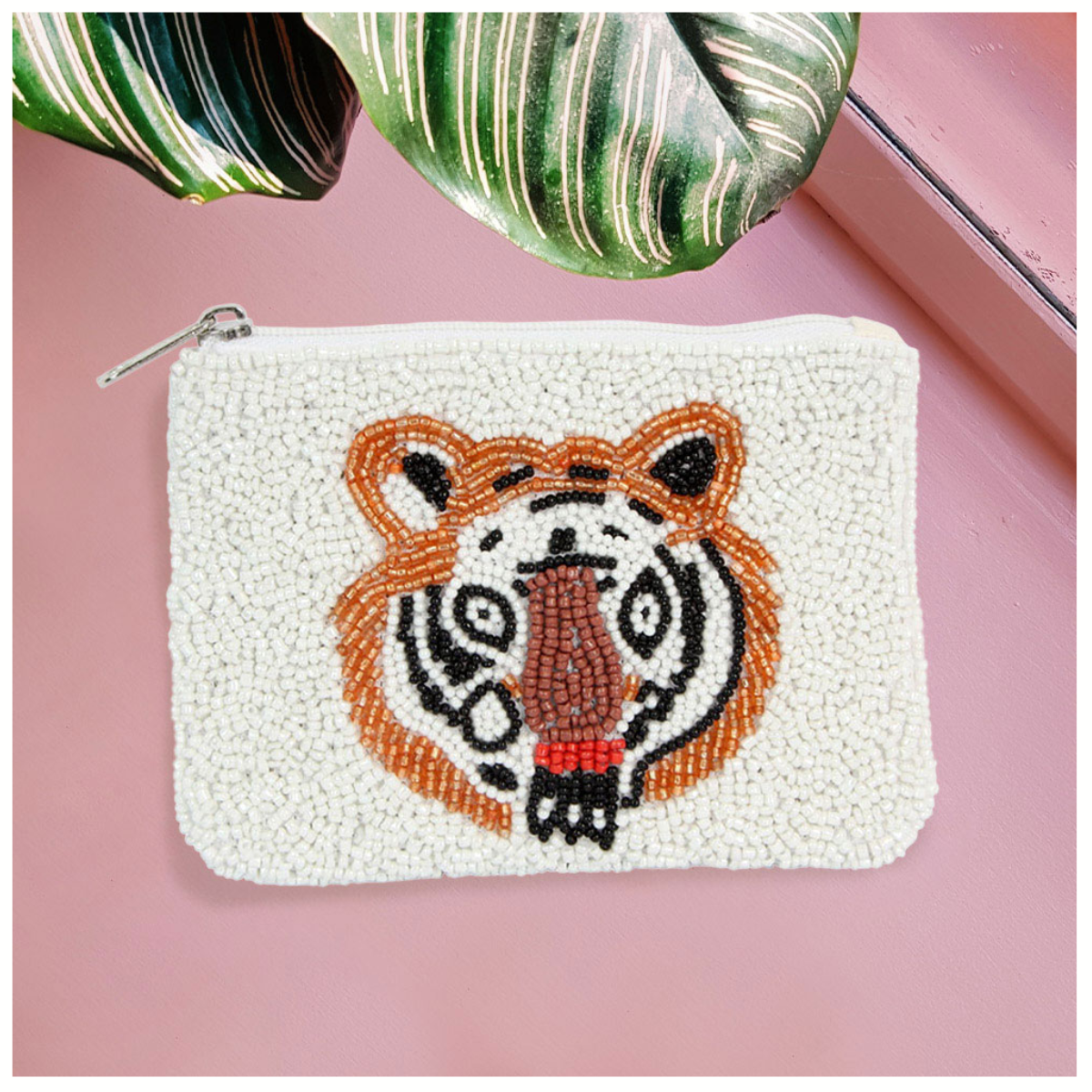 The Seed Bead Accented Mini Pouch Bag Assorted by Wona Trading features a tiger face crafted from seed beads. This stylish white zipper coin pouch makes a perfect gift for fashion-forward friends.