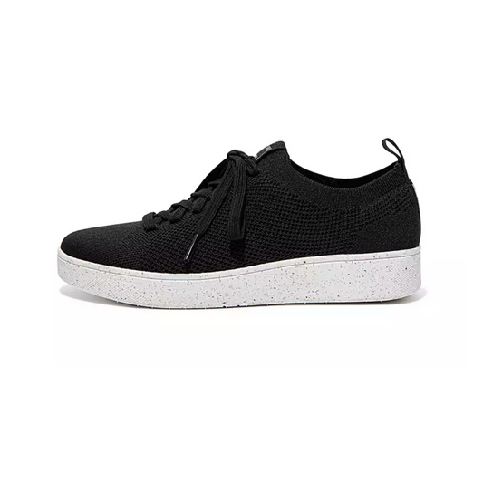 A side view of the black Rally e01 Knit Tennis Shoes by FITFLOP USA LLC, featuring a white speckled sole, highlights the future of sustainable footwear.
