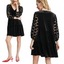 Model wearing the Umgee Tiered Velvet Mini Dress in Black, featuring polka dot lace sleeves. Shown from front and back views and styled with red slingback heels.