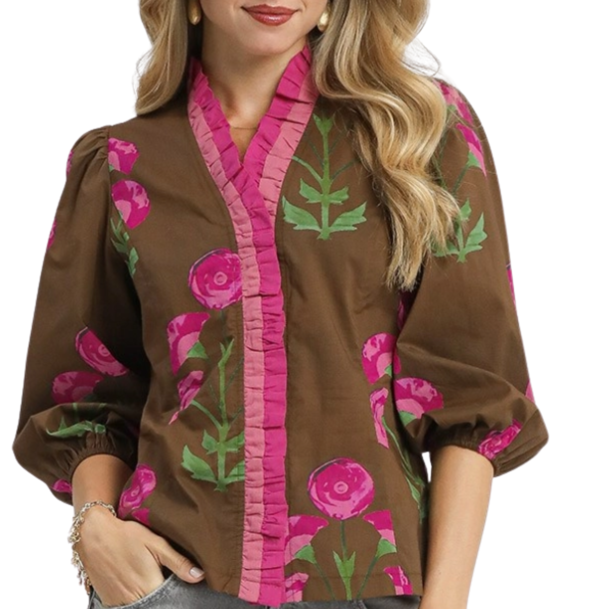 A woman wears the Umgee Floral Print Ruffle Top, featuring a brown cotton base with pink floral patterns, green leaves, pink-trimmed collar, and three-quarter sleeves.
