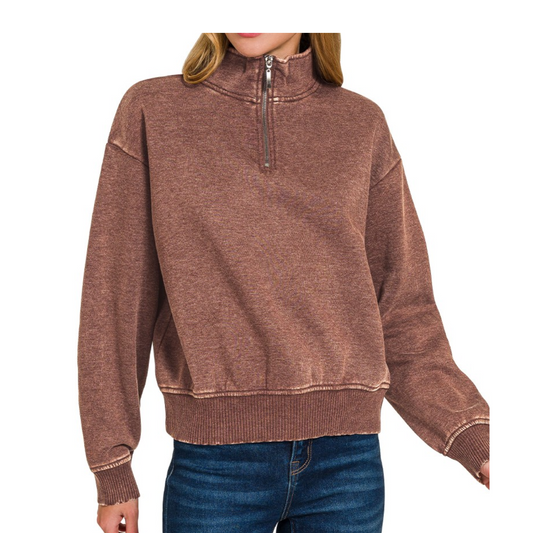 A person wears the Zenana Acid Washed Fleece Half Zip Pullover with long sleeves and blue jeans, standing against a white background.