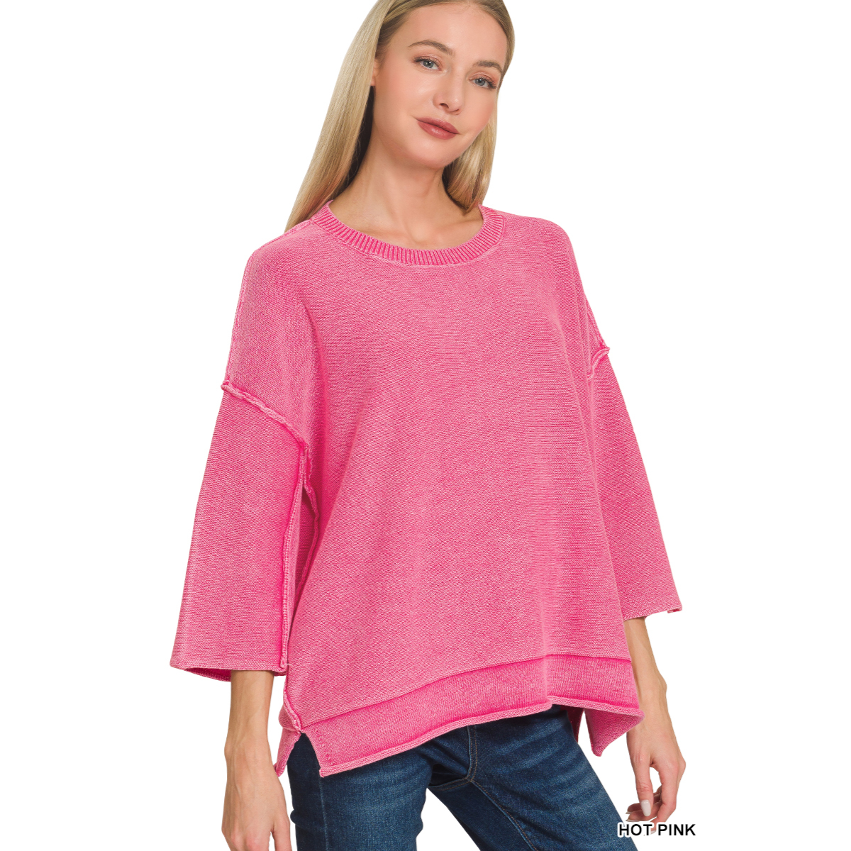 A woman wears the Zenana Washed 3/4 Sleeve Boxy Cotton Sweater in hot pink with blue jeans, standing against a white background.