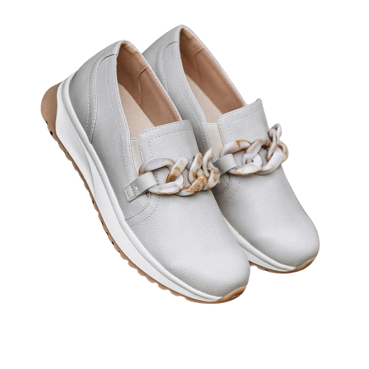 The Rory Loafer in Taupe by Yellow Box showcases a chic chunky chain hardware detail in white and beige, paired with a sleek white sole and light brown tread. These stylish slip-on sneakers by YELLOW BOX - CIT are not only fashionable but also functional, featuring the convenience of a removable insole.