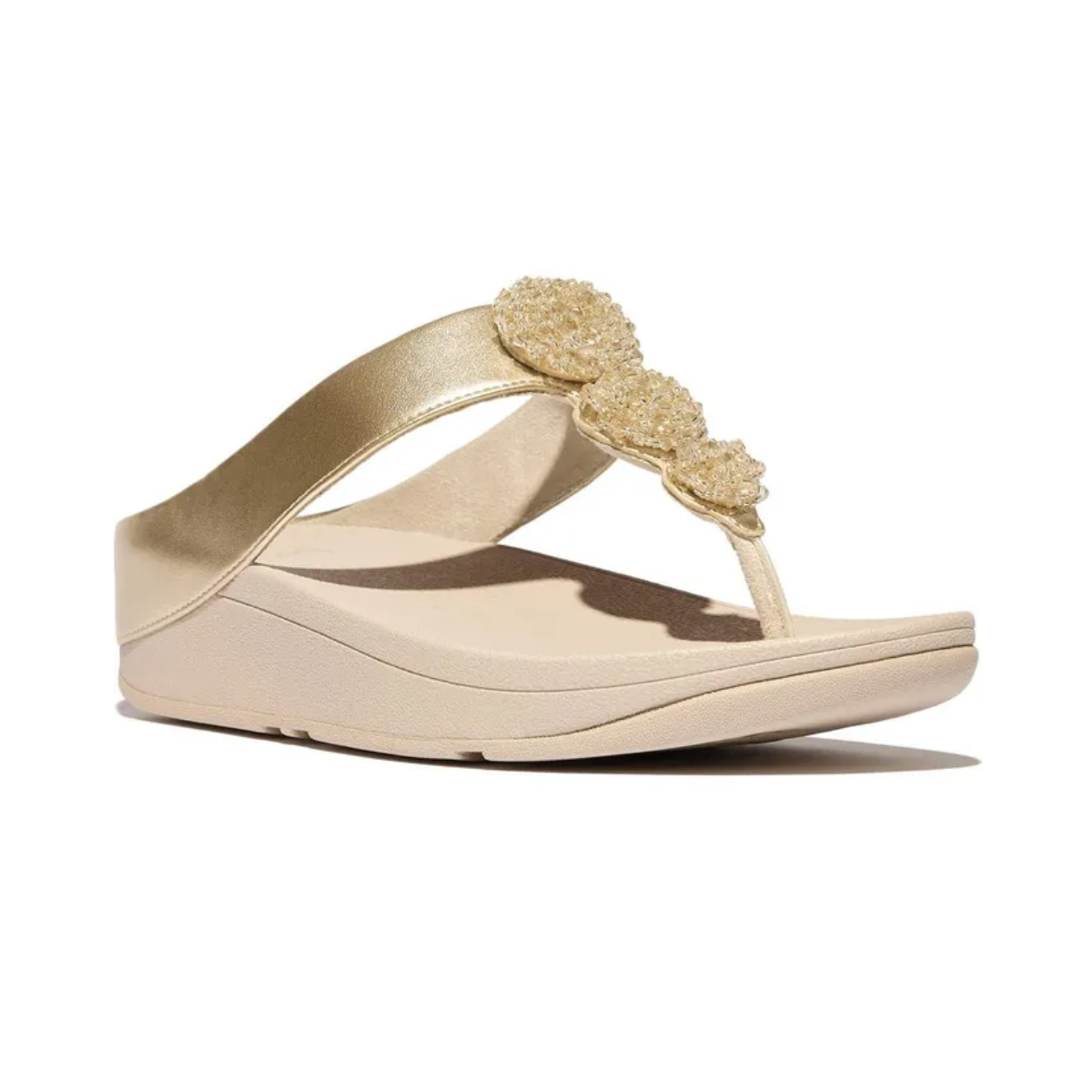 The Fino Beadie Metallic Flip Flop in Platino by FITFLOP USA LLC features beaded embellishments on the strap, a thick slip-resistant sole, an open toe design, and a cushioned footbed for all-day comfort.