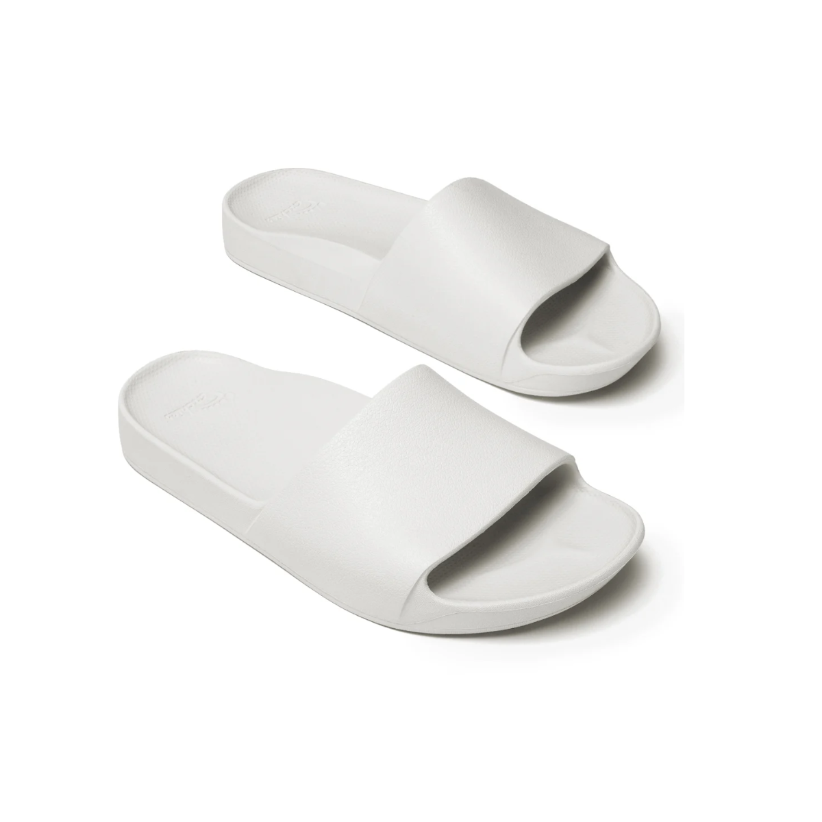 The Archies Slide Sandals from Flipflops & Whatnots are white rubber slides with a single wide strap and flat sole, featuring orthotic support to ease Achilles tendonitis discomfort.