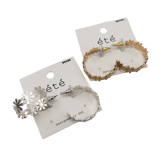 Two pairs of Flower Hoop Earrings elegantly rest on cards. One pair gleams in silver, the other in gold. Each card prominently features the brand name "SPECIAL EFFECTS.