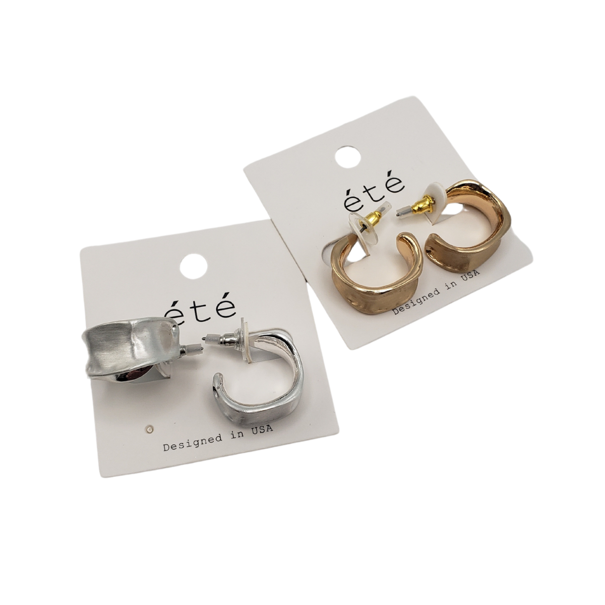 Two pairs of chunky hoop earrings on cards: one silver-toned, one gold-toned with a brushed metal finish. Both cards bear the "SPECIAL EFFECTS" brand and state "Designed in USA.