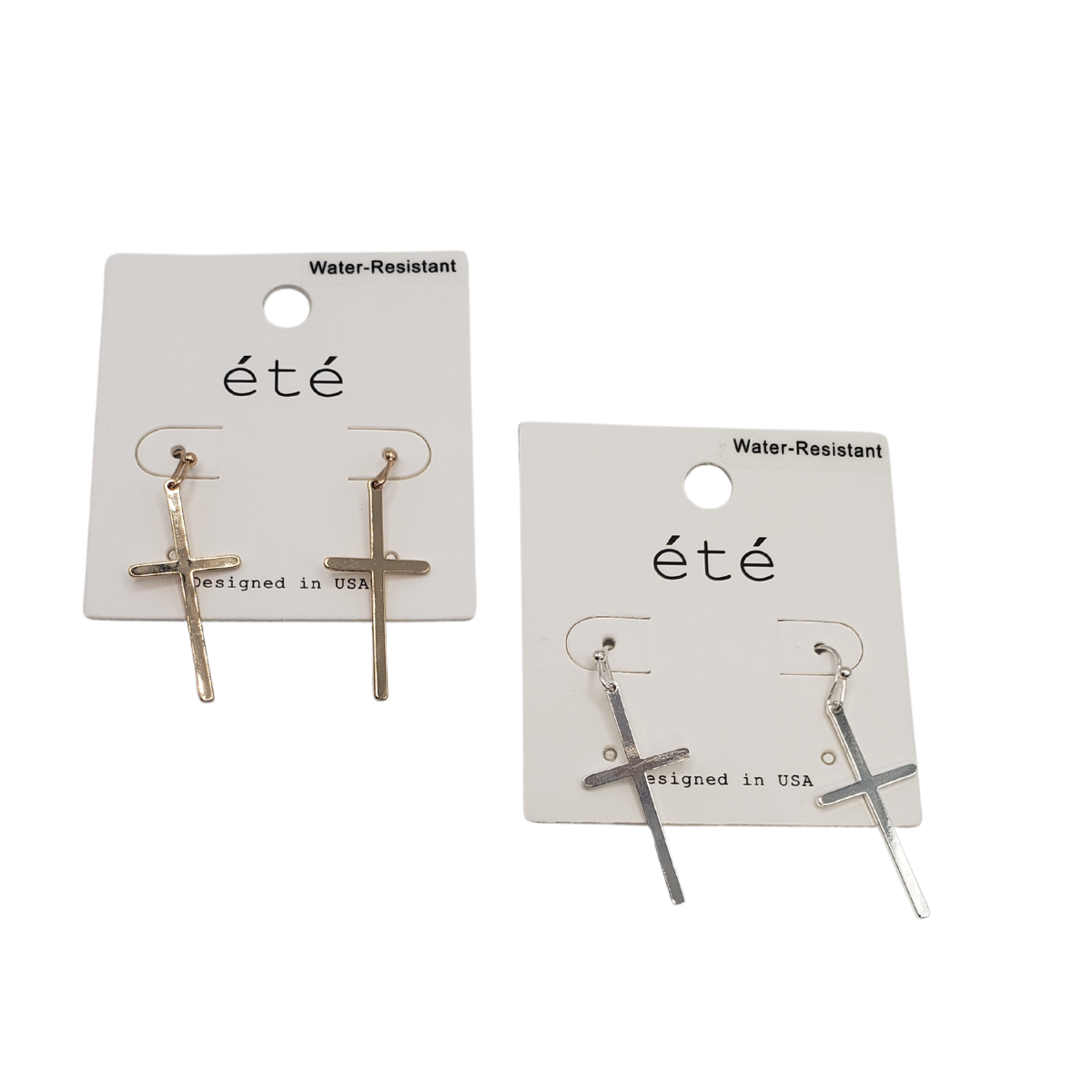 Two pairs of SPECIAL EFFECTS Cross Earrings on white "eté" cards, labeled water-resistant and designed in the USA. One card has gold tone, and the other silver tone options.