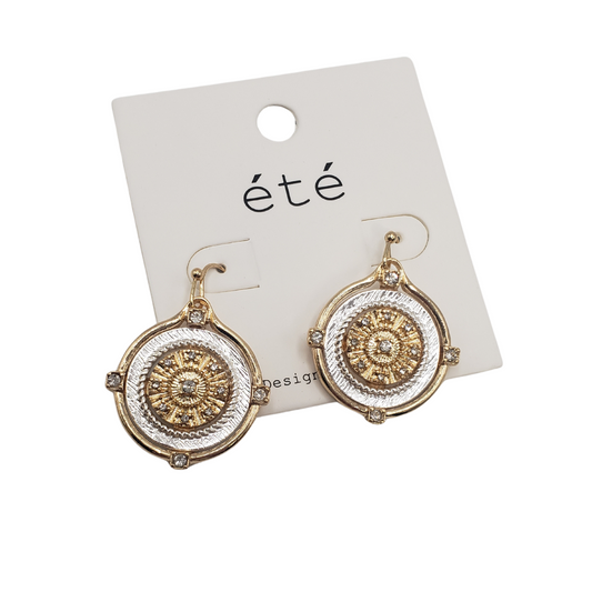 The SPECIAL EFFECTS 2 Tone Disc "Coin" Drop Earrings exhibit a unique textured circular design in gold and silver-tone, presented on a branded card.