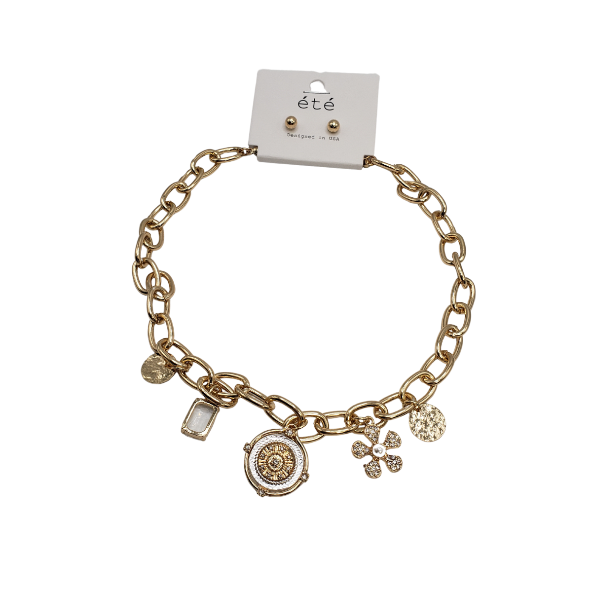 The 2 Tone Disc Charms "Coin" Necklace from SPECIAL EFFECTS features a gold chain with five assorted charms, including a two-tone disc charm, and comes with matching stud earrings on a branded card.