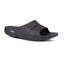 The OOFOS Ooahh Slide by OOFOS LLC is a black slide sandal with a thick sole, open toe, side logo, and patented footbed design providing superior recovery comfort.