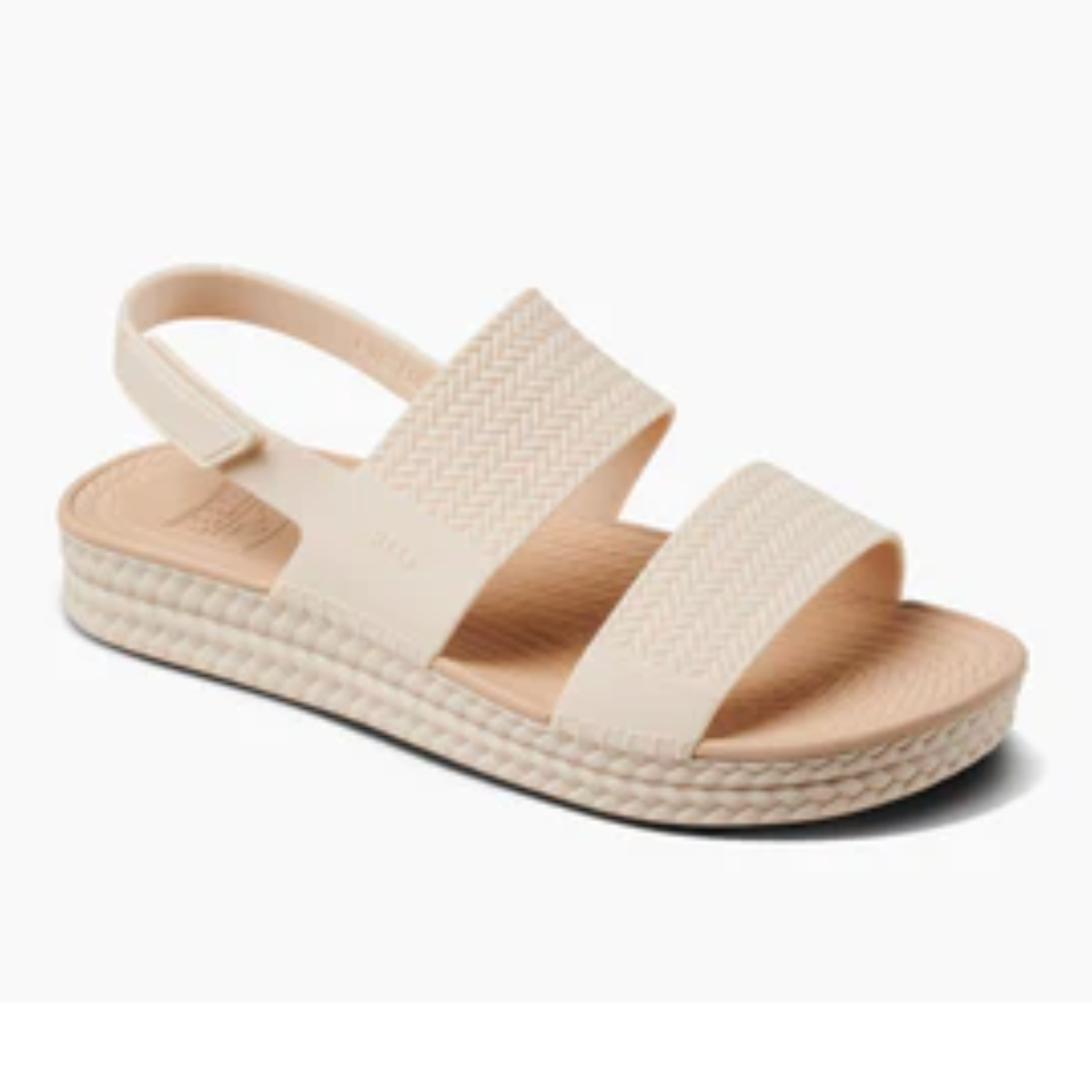 The REEF Water Vista in Vintage Oasis by REEF is a beige sandal with two wide straps, an adjustable back strap made from water-friendly materials, a textured sole for comfort, and stylish espadrille-like braids.