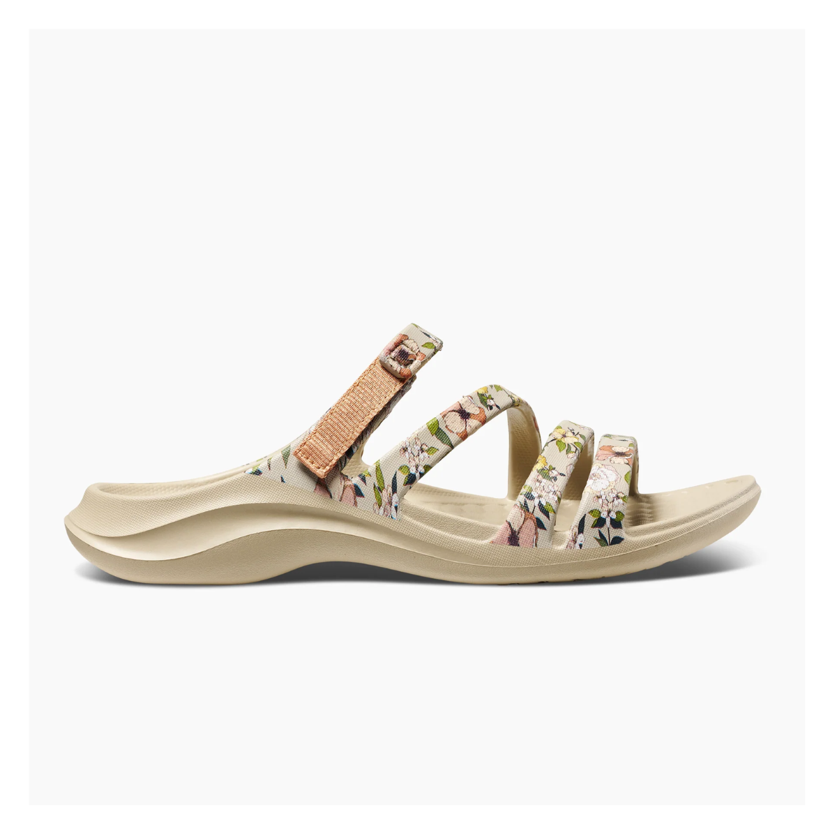 The Lakeshore Sandal in Graphic Driftwood by JOYBEES features floral-patterned straps and a curved sole, displayed side view on a white background. These waterproof sandals combine style and functionality.
