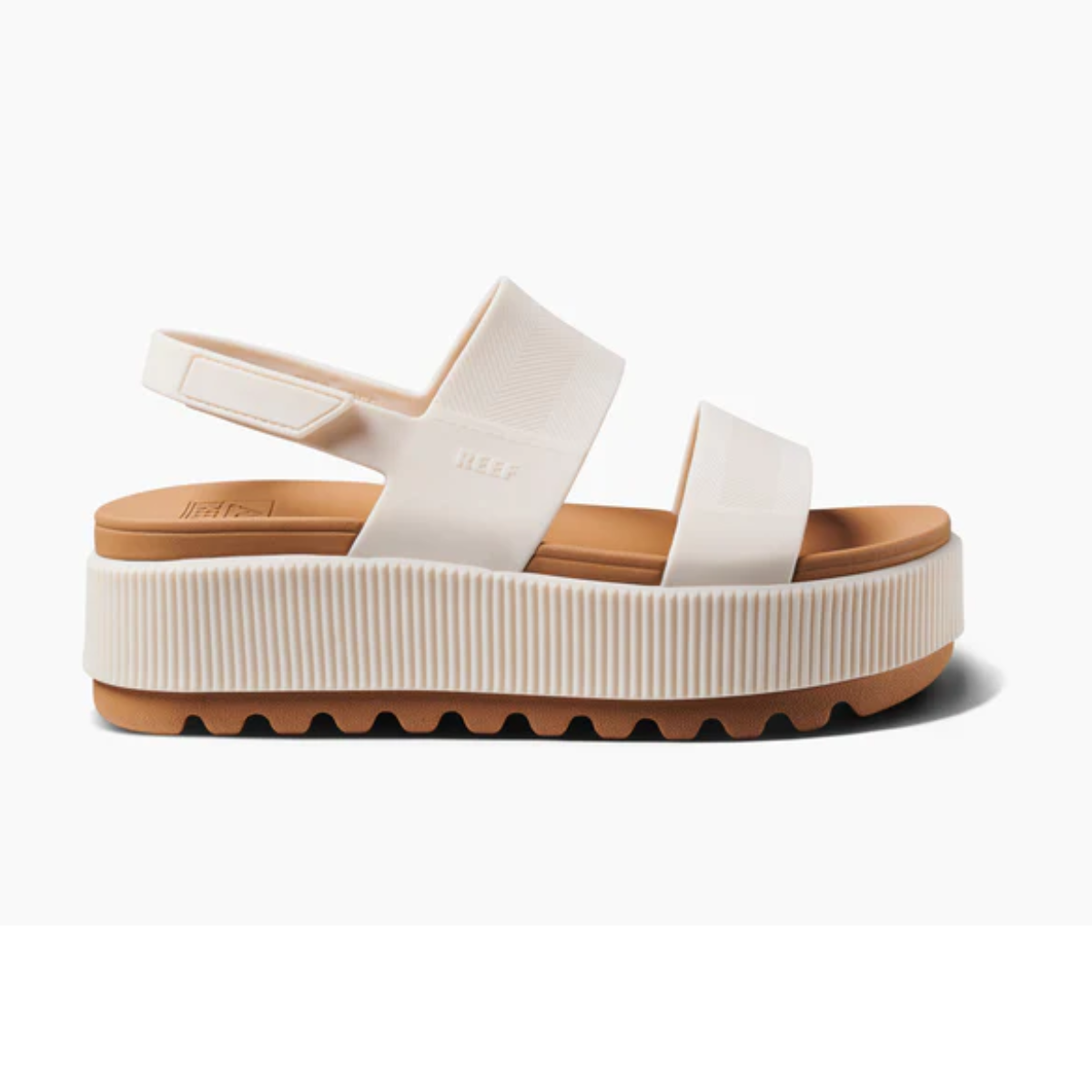 Water Vista Higher in Cloud by REEF: A white, water-friendly platform sandal with two straps and a thick grooved rubber sole, shown from the side on a white background.
