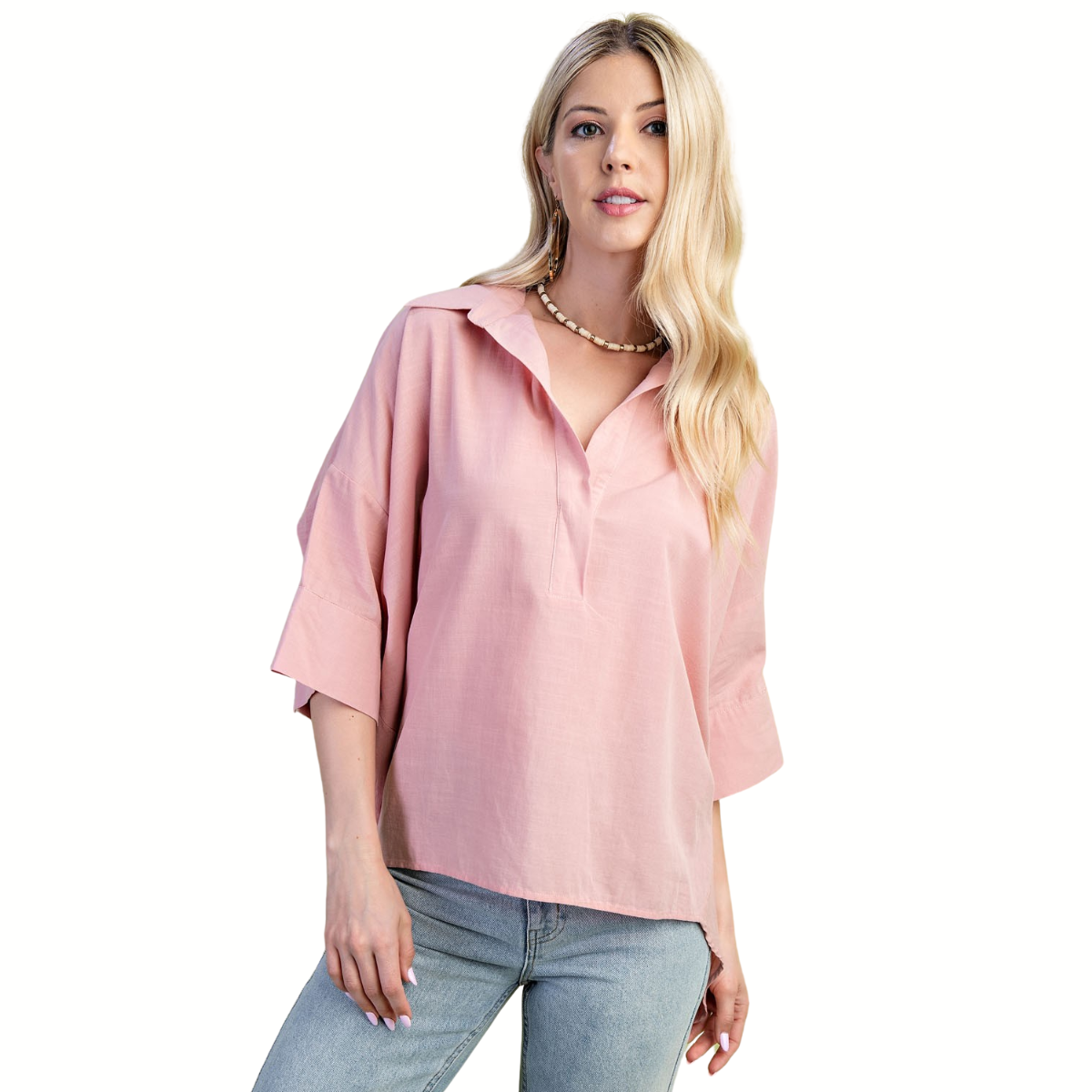 A woman with long blonde hair models the FASHION GO Lightweight V-Neck Popover Shirt in light pink with three-quarter sleeves and light blue jeans, standing against a white background.