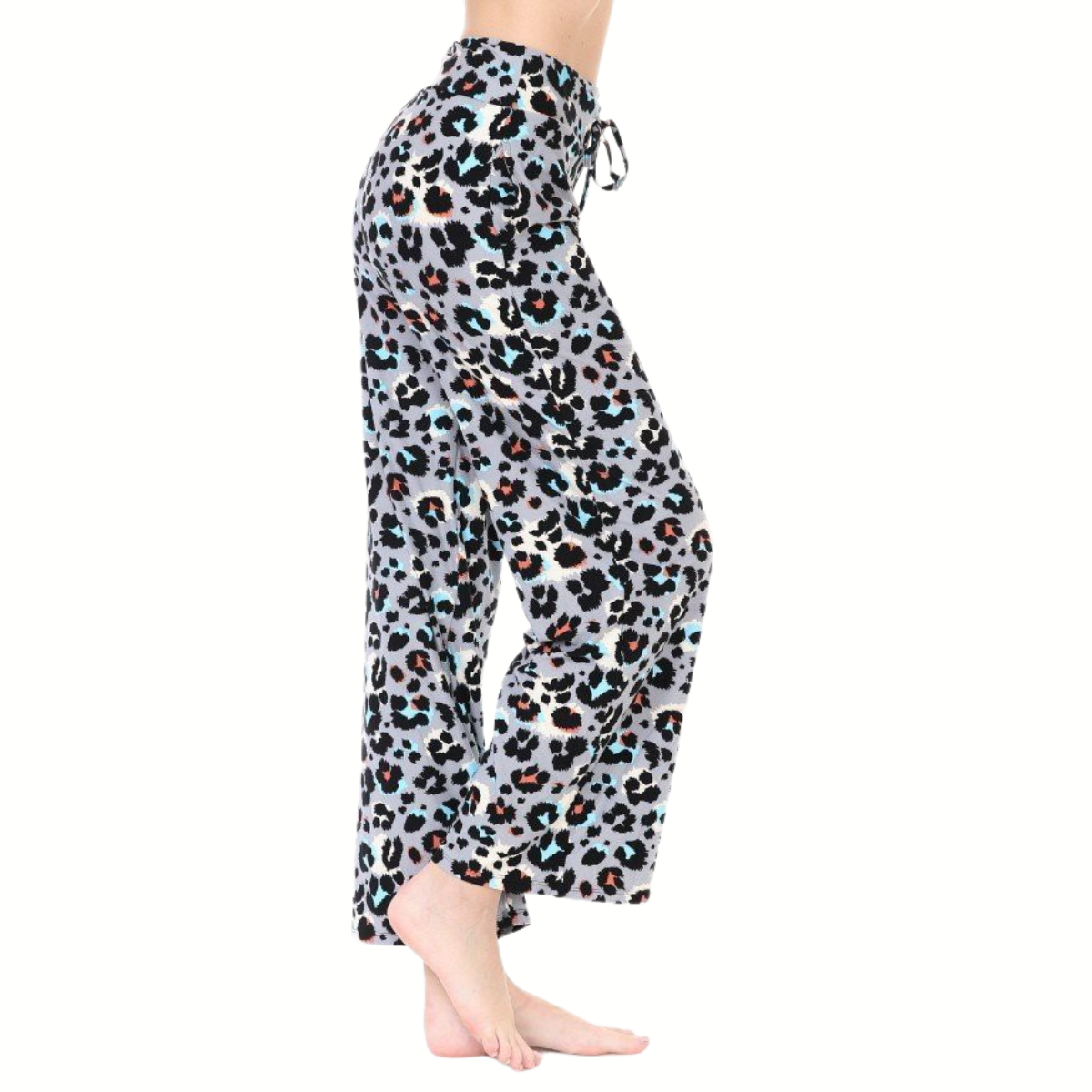 A person stands barefoot in FASHION GO's Buttery Soft Pajama Pants with Drawstring, featuring a loose fit and multicolor leopard print.