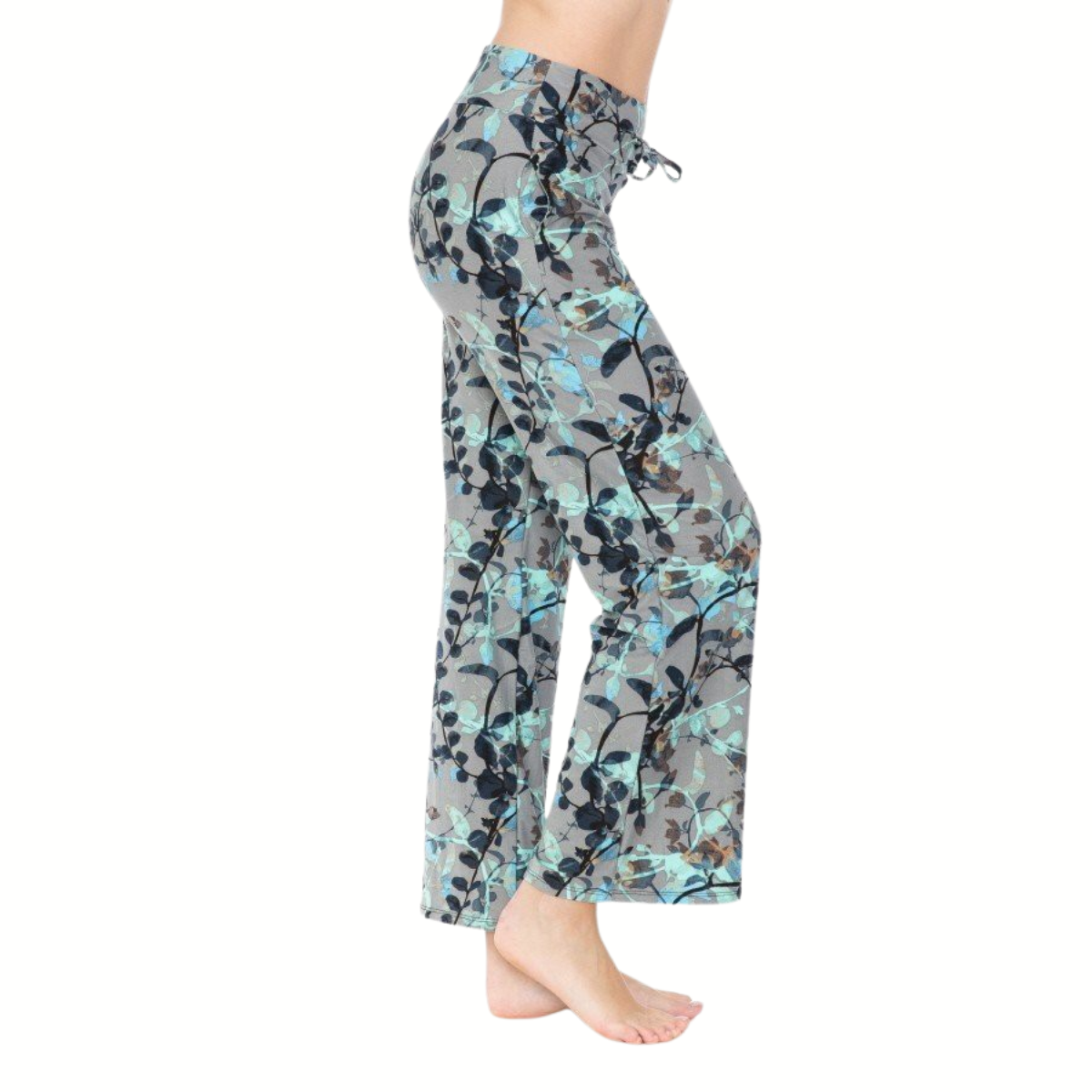 A person is shown from the side, barefoot on a white background, wearing FASHION GO Buttery Soft Pajama Pants with Drawstring featuring a loose fit and gray and blue floral pattern.