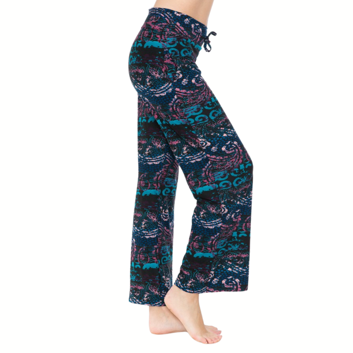 A person wearing FASHION GO Buttery Soft Pajama Pants with Drawstring, showcasing teal, pink, and black patterns. These loose-fitting pants feature an elastic waistband and functional pockets for comfort and convenience.