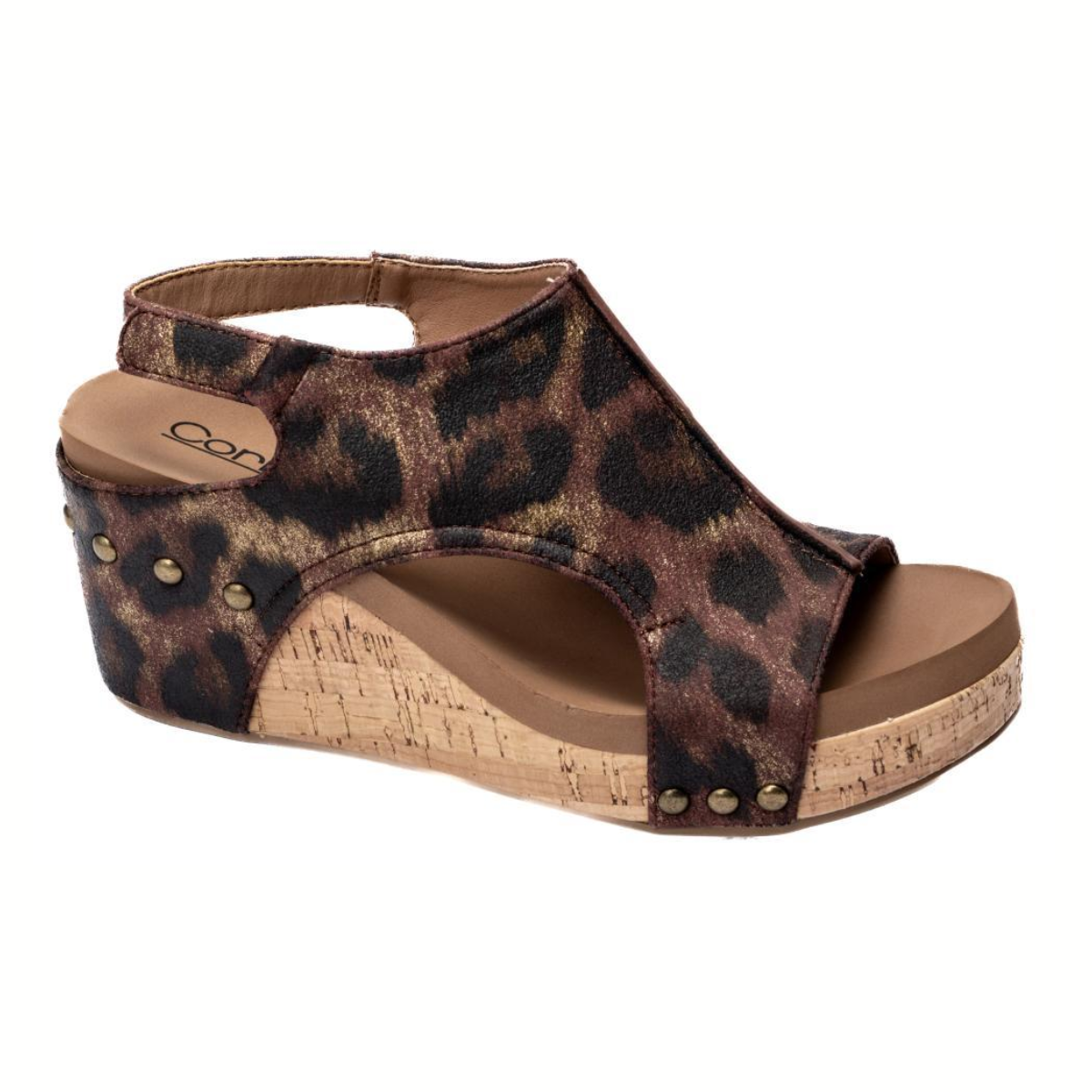 The Carley in Washed Leopard by CORKY'S FOOTWEAR INC features a supportive footbed, brown and black leopard print upper, open toe, ankle strap, decorative metal studs, and a stylish 3-inch cork wedge heel.