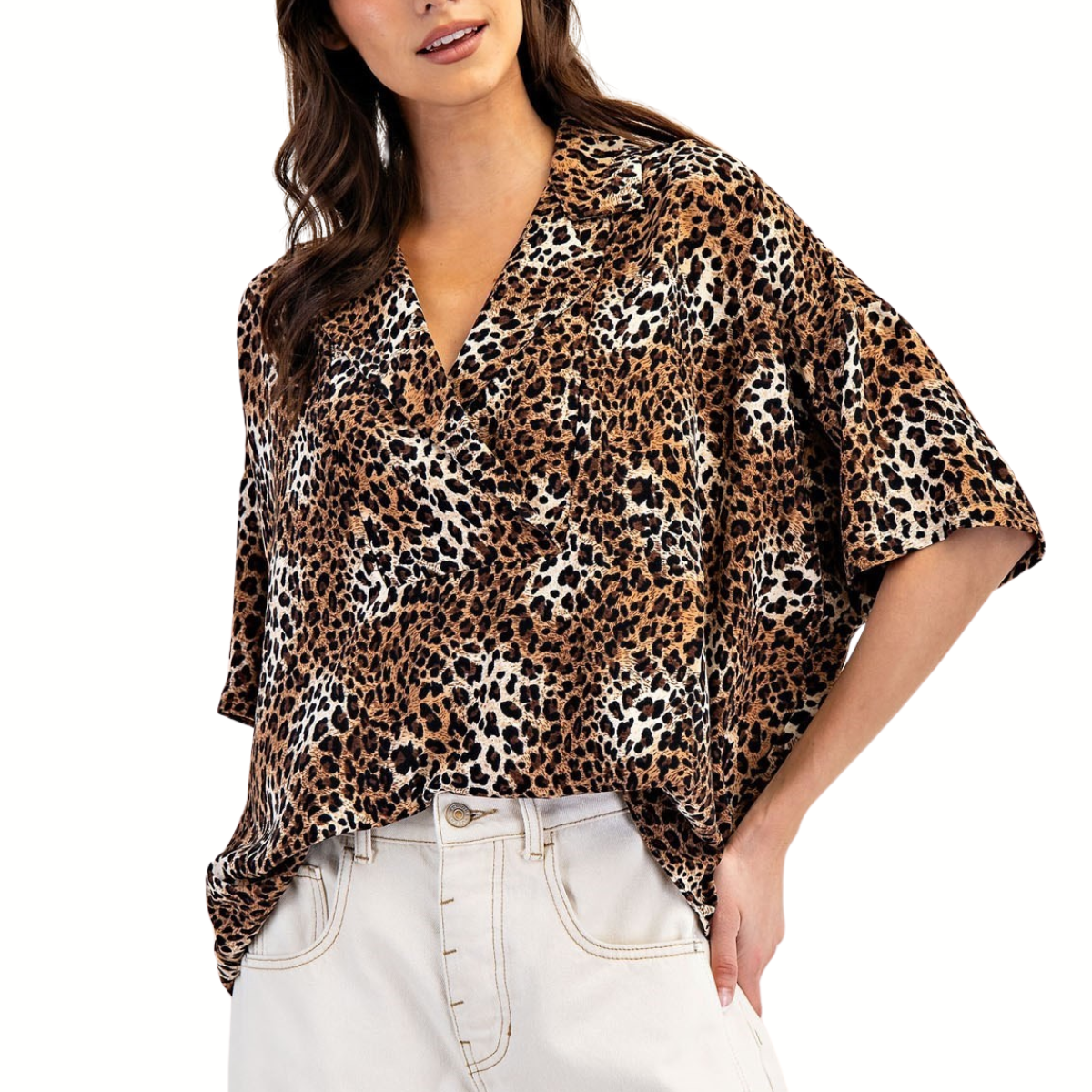 A woman wears the FASHION GO Leopard Printed Half Sleeve Blouse with a notched lapel collar, tucked into high-waisted light-colored pants.