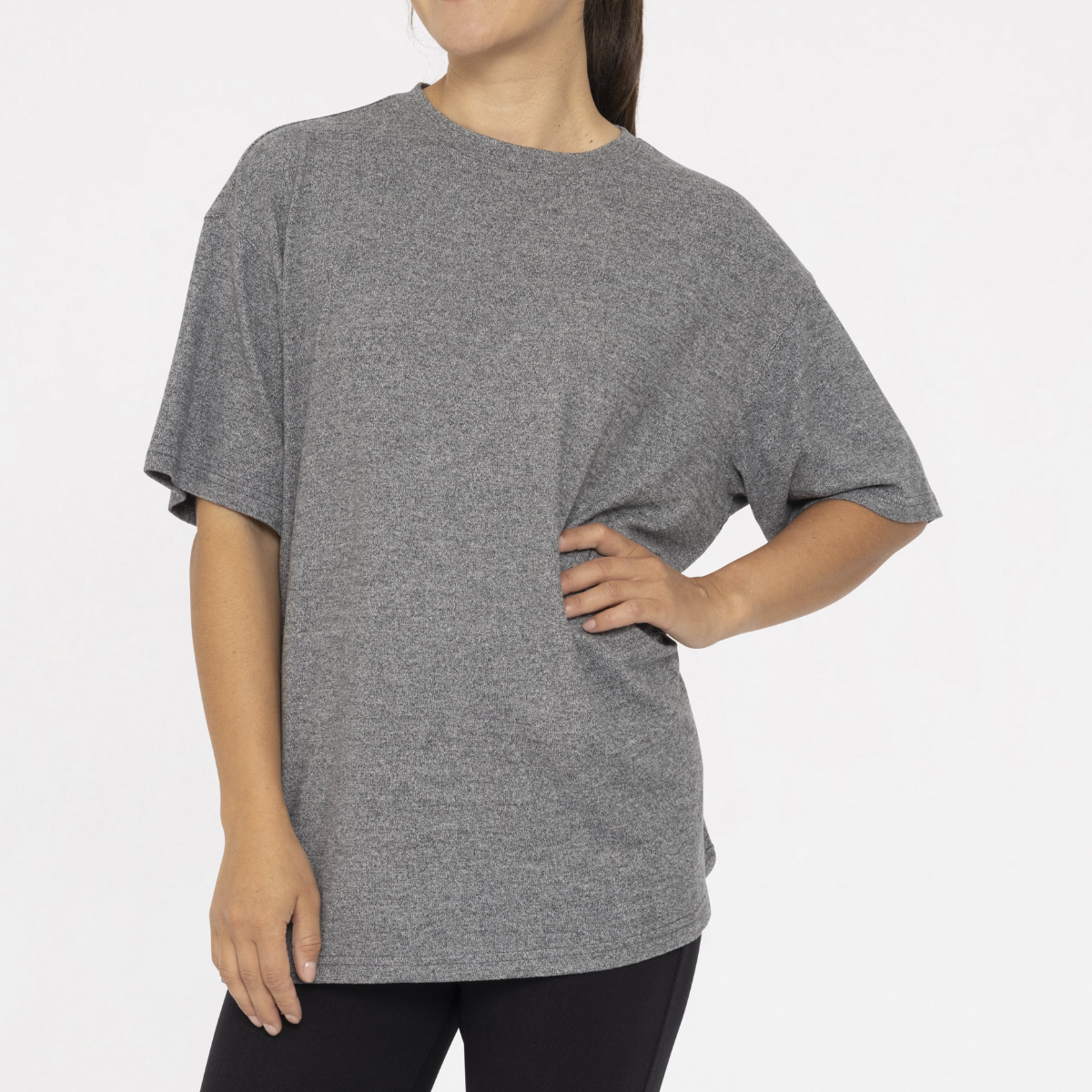 Model stands against a white background wearing the Mono B Brushed Hacci Boyfriend Tee and Wide Leg Pant Set, with one hand on their hip.