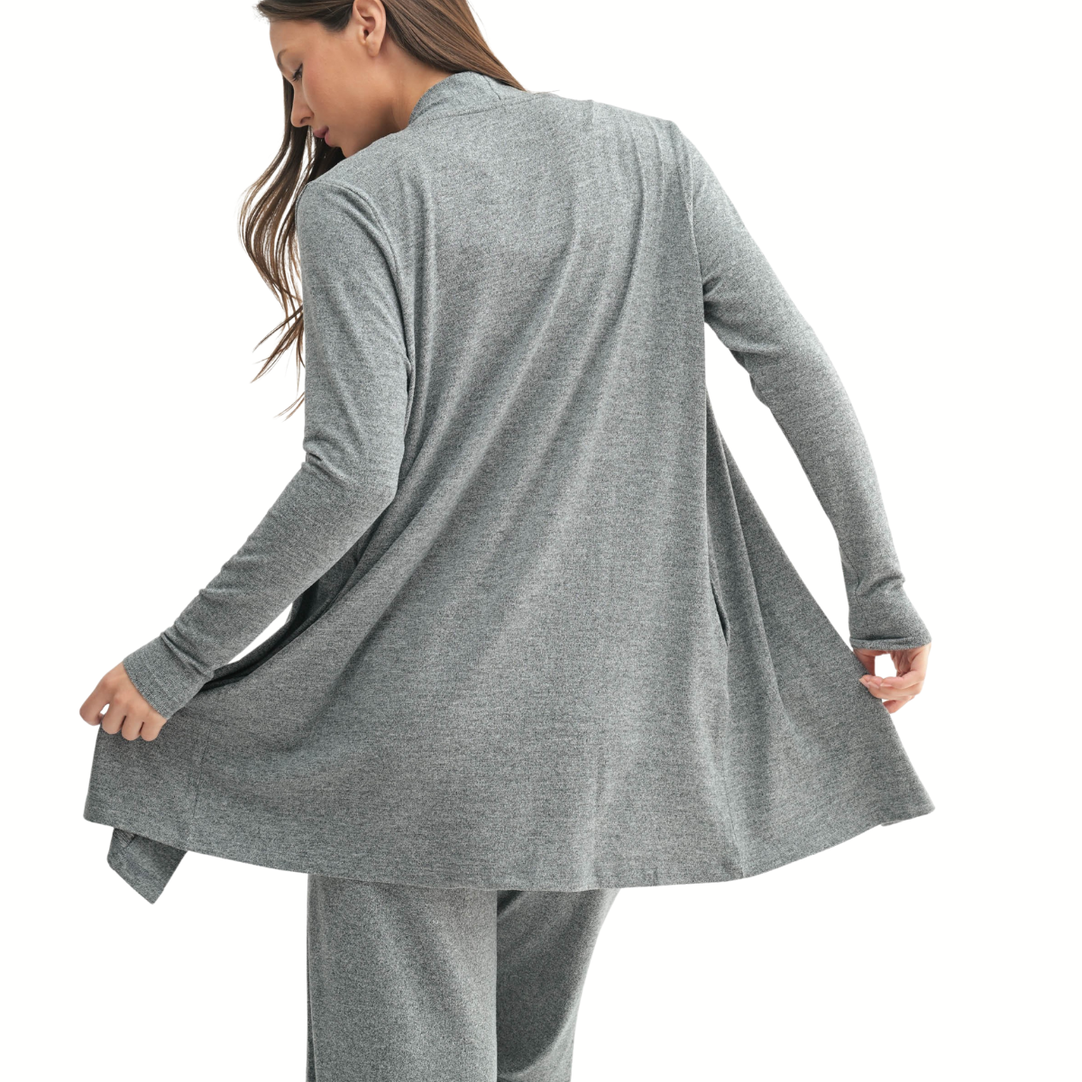 A woman, seen from behind, holds the edge of her Mono B Brushed Hacci Open Cardigan with matching pants.