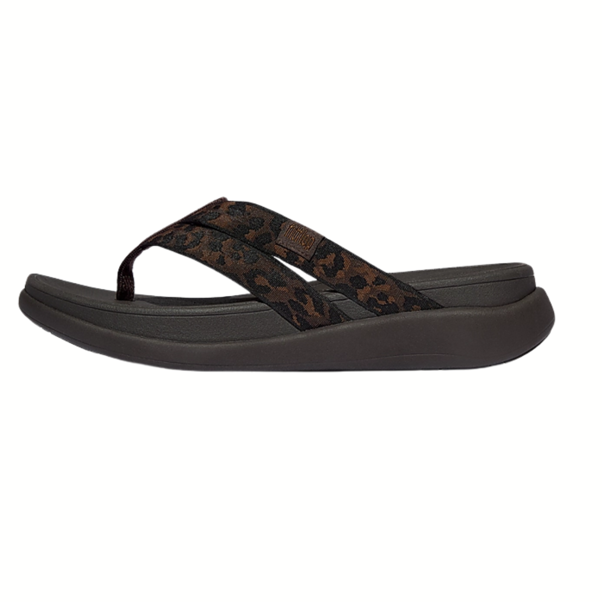 The Fit Flops F-MODE Go Leopard Webbing Strappy Flip-Flop features a thick, contoured sole and a black-and-brown leopard print fabric strap, shown in profile on a white background—ideal for comfort seekers.