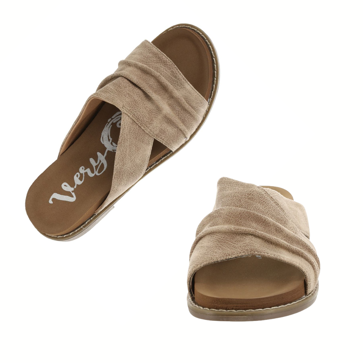 The Jolene 2 in Taupe by VERY G is a pair of tan slip-on sandals with crisscross fabric straps and flat soles, offering relaxed comfort, displayed on a white background.