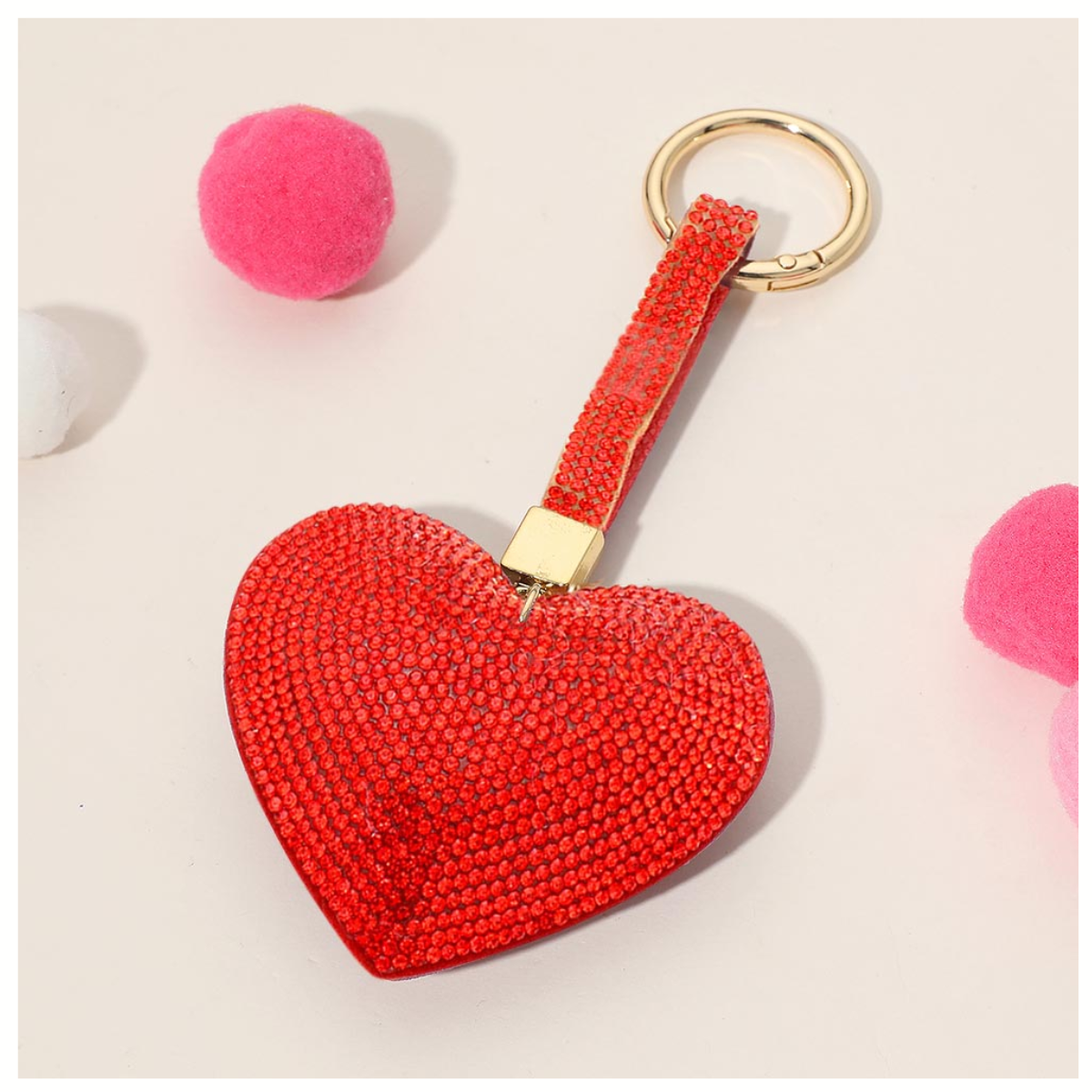 The Wona Trading Bling Heart Key Chain Bag Charm Assorted Colors features a rhinestone-studded heart and gold ring, perfect as a sparkling charm for your bag or keys.