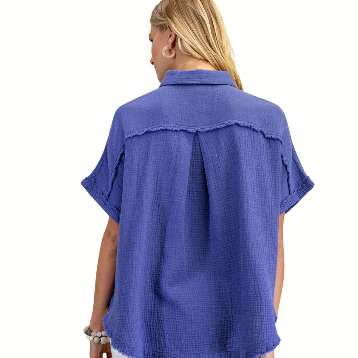 A person with long blonde hair is seen from the back wearing the Gigio Gauze Button Down Top with Distressed Raw Edge, a short-sleeved blue textured blouse, against a white background.