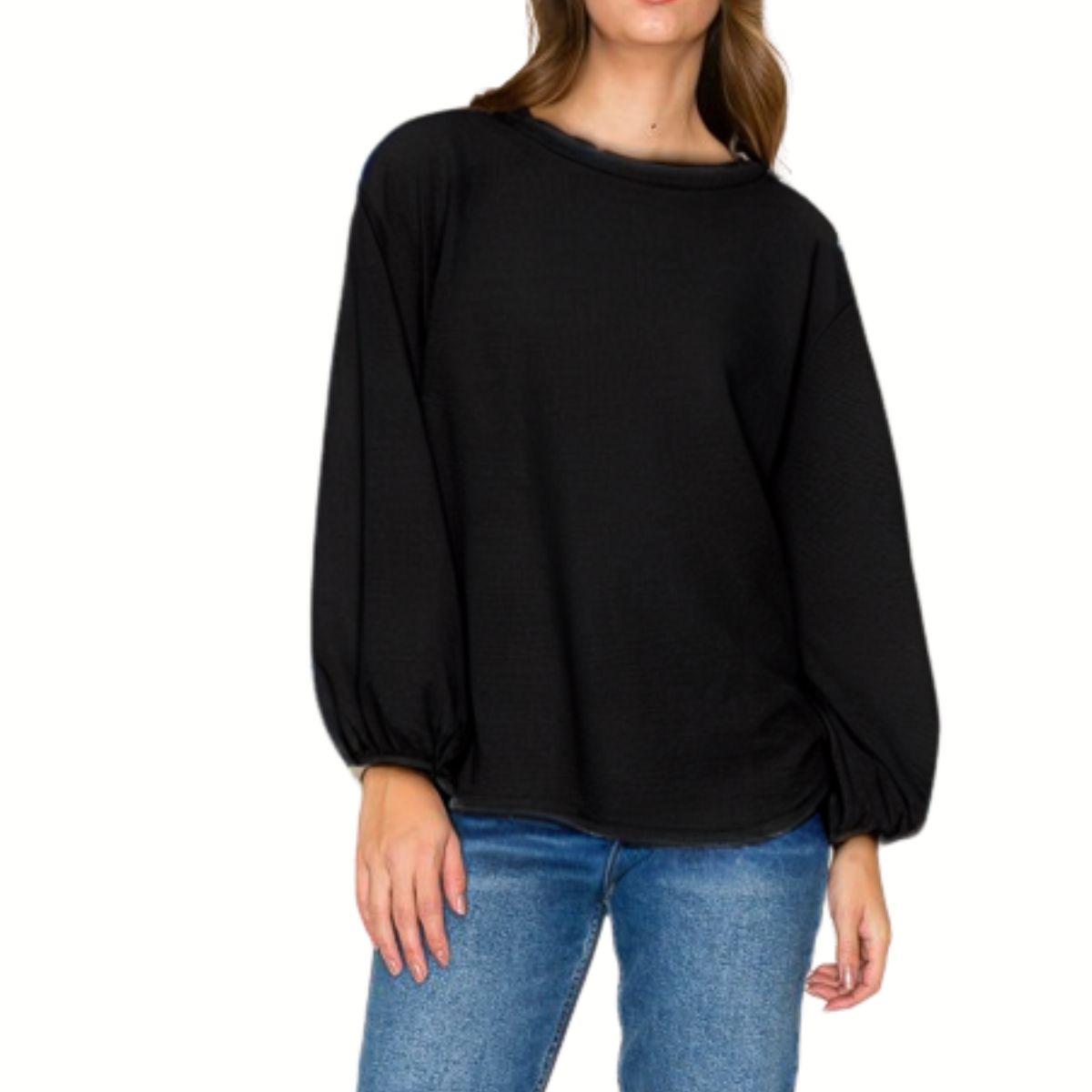 A woman wearing the FASHION GO Round Neck Cloudy Knit Long Sleeve Top with balloon sleeves and blue jeans stands against a white background.
