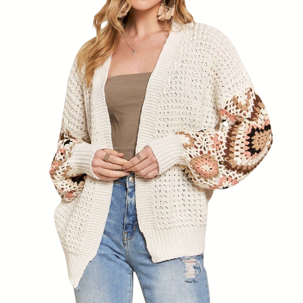 A woman models the Fashiongo Crocket Sleeve Cardigan Sweater, featuring crochet granny square sleeves, over a brown tube top and ripped blue jeans against a white background.