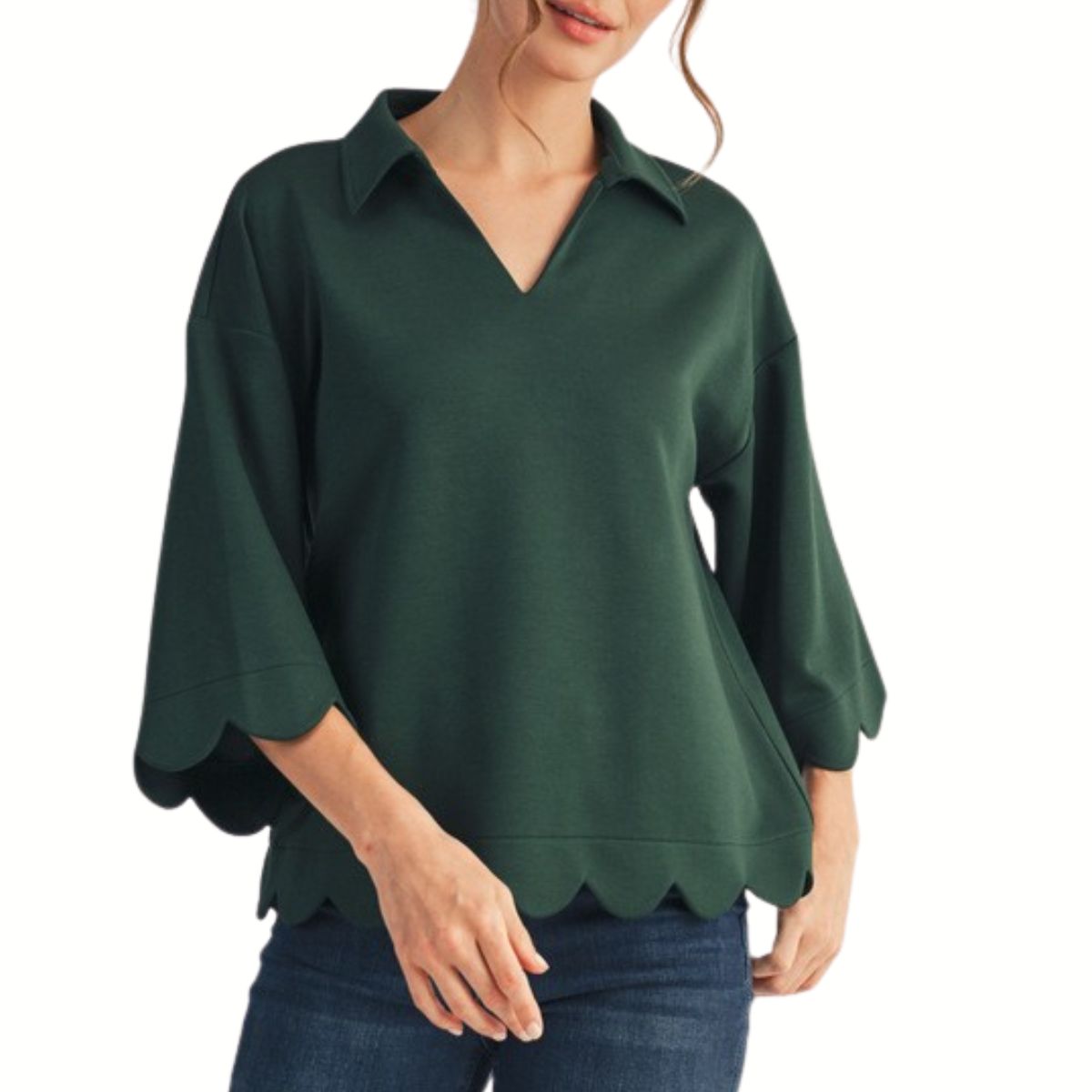 Woman wearing a FASHION GO Scallop Edge Detail Solid Top with three-quarter scalloped sleeves and hem, paired with dark blue jeans.